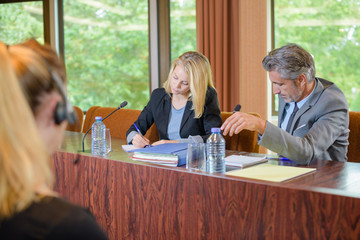 People at desk in conference