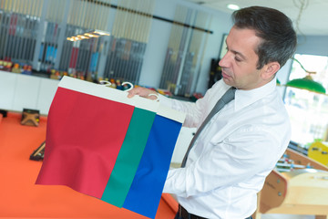 man holding a fabric sample