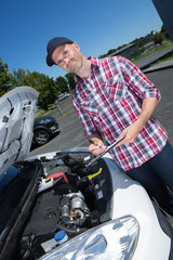 Fototapeta na wymiar handsome man checking car engine