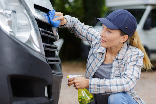 Woman Hand Washing A Car Headlights