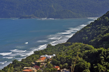 Waves crashing on the beach, with blue sea