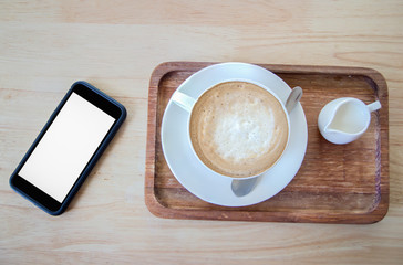 coffee and milk on wood table with mobile phone