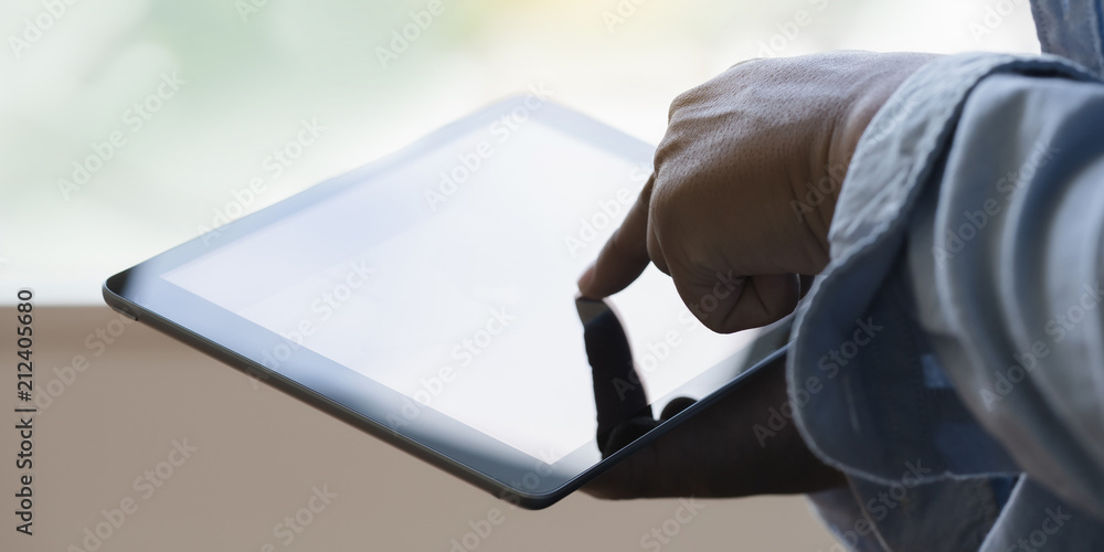 Poster digital tablet computer close up man using tablet hands man multitasking with isolated screen