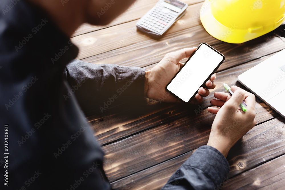 Aufkleber engineering using phone mobile on desk