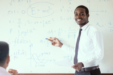 African science teacher teaching in the classroom.