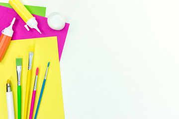 Fototapeta premium school stationary set – brushes, colored paper, watercolor paints on white background with copy space