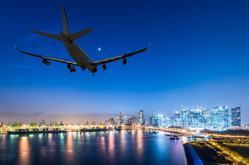 Fototapeta na wymiar airplane landing in a night city