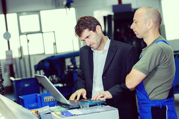 boss and worker on work bench