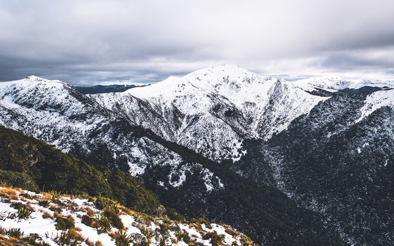 The stunning landscape of the snowy mountain on a foggy misty cloudy day. Kahurangi national park, New Zealand.  Dramatic photography effect.