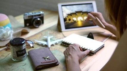 Young women planning vacation trip and searching information on a tablet, Travel concept