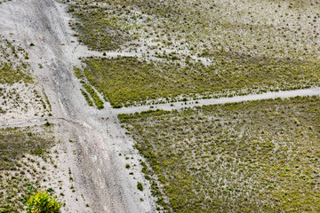 grass,  traffic track and trail on barren sand