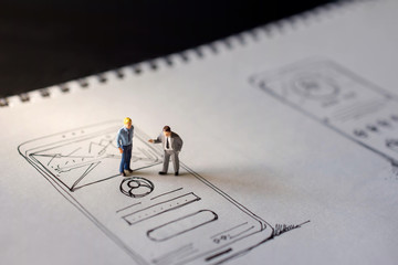 User Experience Concept. present by two Miniature Figure of Businessman standing on Paper of...