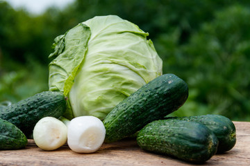 Fresh green vegetables on rustic wooden table outdoor