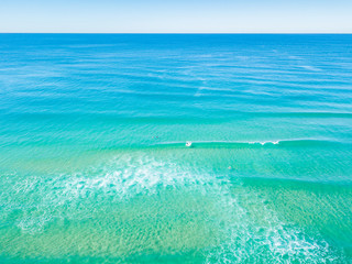 Fototapeta na wymiar An aerial view of the water at the beach on a clear day on the Gold Coast in Australia