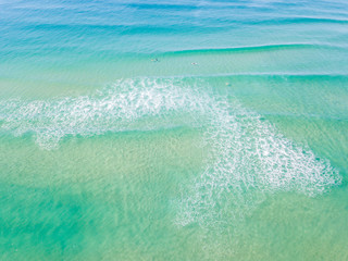 An aerial view of the water at the beach on a clear day on the Gold Coast in Australia