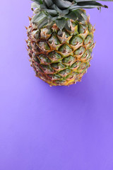 Pineapple on purple background, exotic fruit top view, pineapple for designer in pop art style, vegetarian food in minimalism style, minimalism