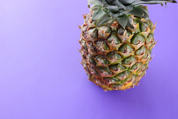 Pineapple on purple background, exotic fruit top view, pineapple for designer in pop art style, vegetarian food in minimalism style, minimalism
