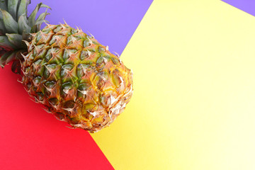 Pineapple on a multicolored background, tropical fruit top view, pineapple in pop art style, vegetarian food in minimalism style, fruit salad