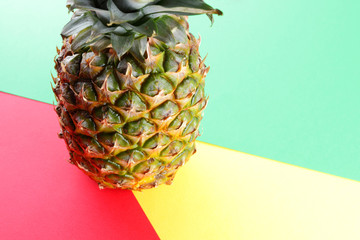 Pineapple on a multicolored background, tropical fruit top view, pineapple in pop art style, vegetarian food in minimalism style, fruit salad