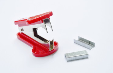 red staple remover and refill on white table
