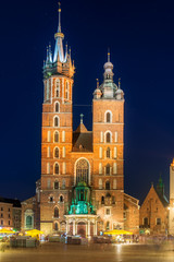 night view of the market square and the church in the center of Krakow