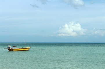Naklejka na ściany i meble Lonely Boat on a tropical Sea