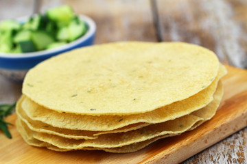 Stack of crunchy Indian papadums on wooden surface
