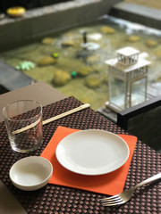 table setting on bamboo towel for oriental lunch near a fountain