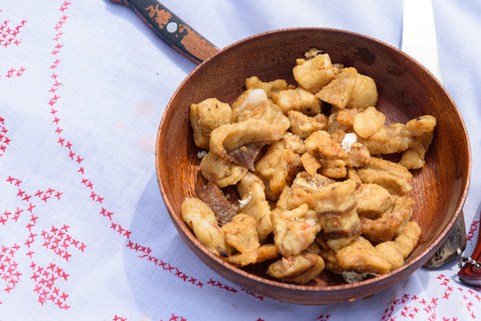 pork cracklings in wooden bowl,serbian cvarci