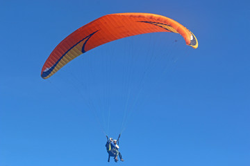 Tandem paraglider flying