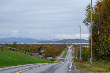 Fototapeta premium Lakselv Norway, city seen from a hill with mountains on the other side of water