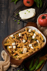 Fusilli pasta with zucchini, goat cheese and green peas