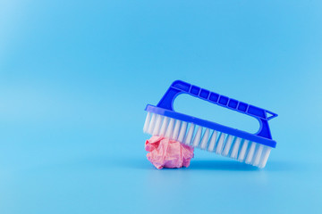 Plastic Scrub Brush with Rubbish on a Blue background