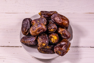 Date fruits on the white wooden table
