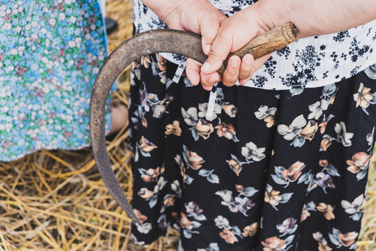 Sickle In A Woman's Hand