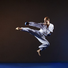 In a high jump athlete in karategi beats kick leg
