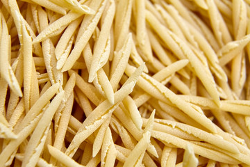 Dry Uncooked Trofie Italian Pasta . Food Background