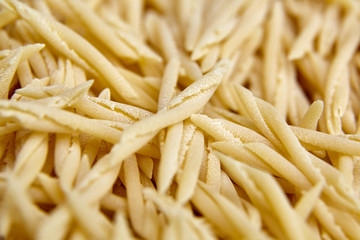 Dry Uncooked Trofie Italian Pasta . Food Background