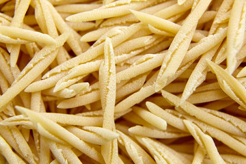 Dry Uncooked Trofie Italian Pasta . Food Background