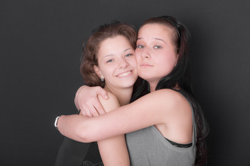 studio portrait of two girlfriends