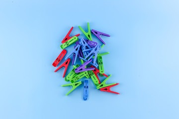 Clothes pegs On Blue Background