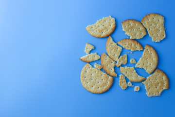 Fototapeta na wymiar Broken Jacob's Weetameal Biscuits On Blue background