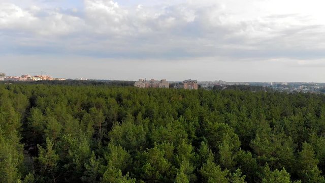 Building a city in the forest. Aerial survey of construction of a residential complex