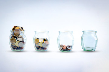 The coins in bottle on green and White background. The ray sun on  the coins in the bottle. The...