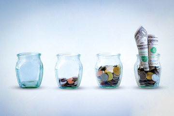 The coins in bottle on green and White background. The ray sun on  the coins in the bottle. The concept of growth for the save money.