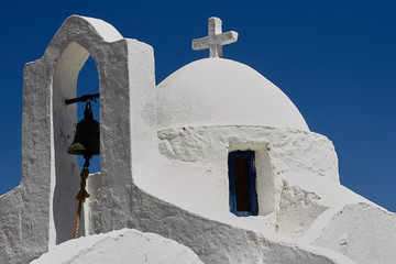 Facade detail of the traditional greek chapel with white plastered walls