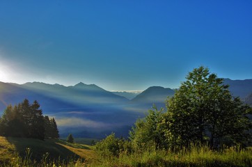 first rays of the sun, early morning in the mountains