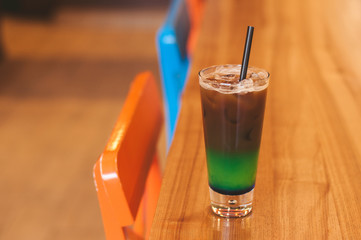 Ice coffee wich blue green cocktailcold coffee and green, blue syrup. Summer refreshing cocktail on...