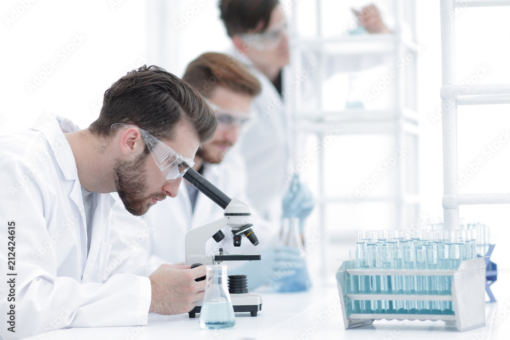 Wall mural background image scientists working with the microscope