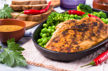 Fried chicken breast with green vegetables